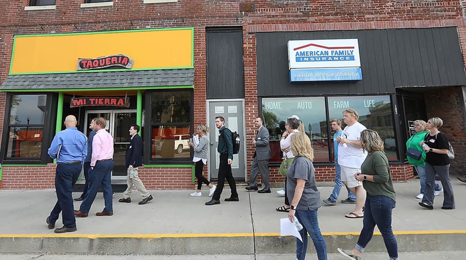 Milan residents and members of Missouri Main Street Connection tour downtown Milan during a community event in September.