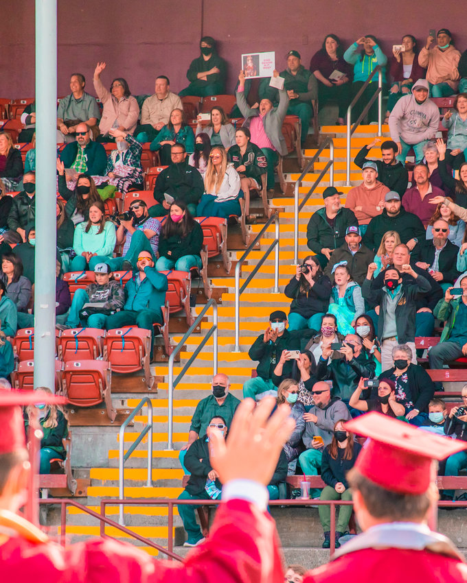Bearcat graduates wave to their parents during a ceremony in Bearcat Stadium at W.F. West on Saturday in Chehalis.