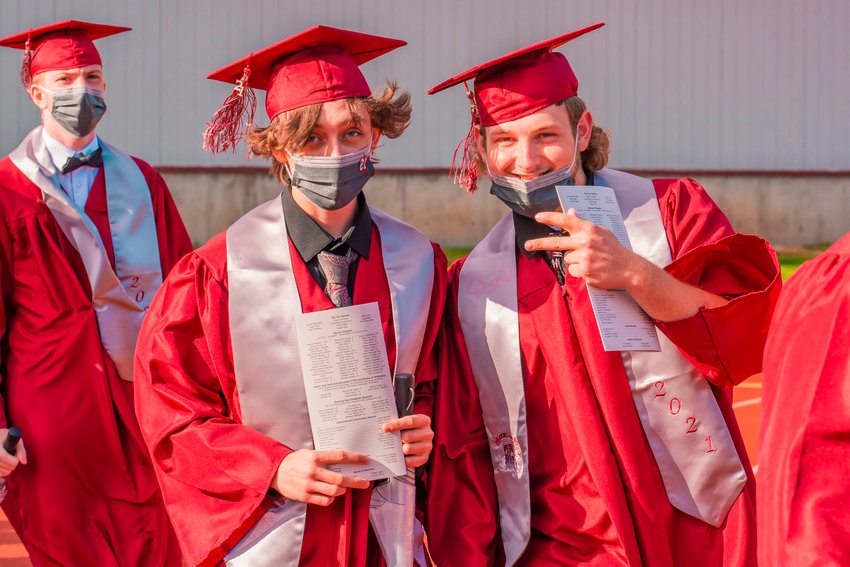 W.F. West graduates sport masks, caps and gowns during a graduation ceremony on Saturday at Bearcat Stadium.