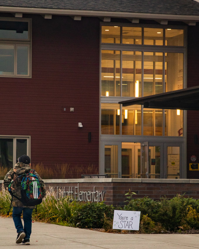 A student carries a backpack to class in front of James W. Lintott Elementary School in Chehalis Wednesday morning.