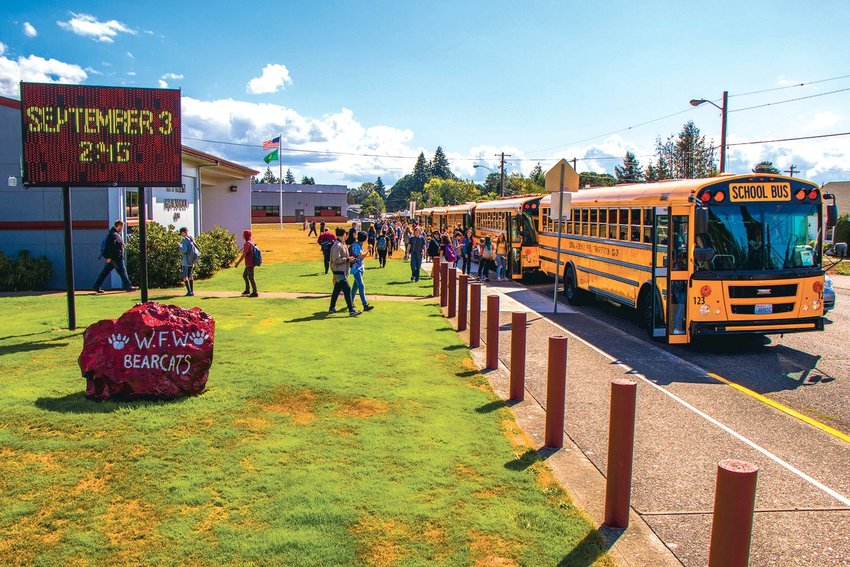 Students flood into buses at W.F. West High School.