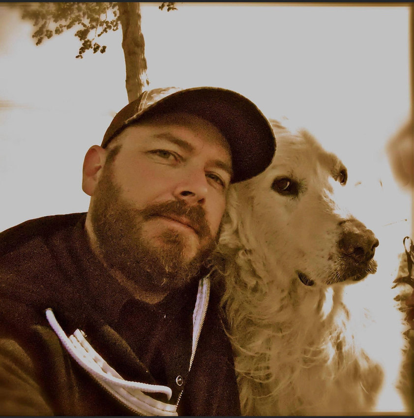 Aron Christensen and a dog are pictured in this photo previously provided by friends and family.