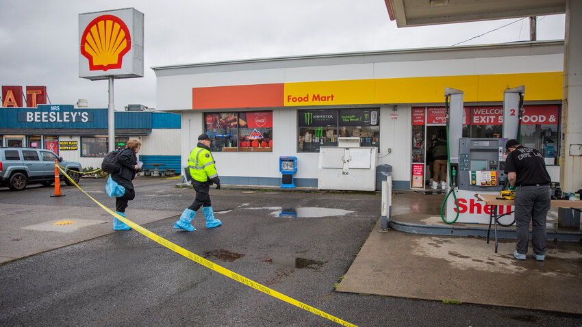 Crews from the Washington State Patrol crime lab, Lewis County Sheriff’s Office and Lewis County Coroner's Office respond to a scene at the Shell gas station located along Mulford Road in Toledo while investigating a homicide on Thursday, May 4, 2023.