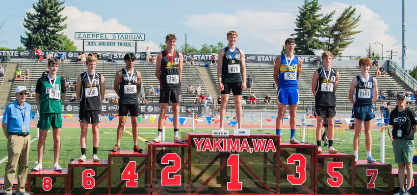 Mossyrock’s Matt Cooper smiles for a photo on the podium after taking first in the 800 meter run at Zaepfel Stadium in Yakima on Saturday.