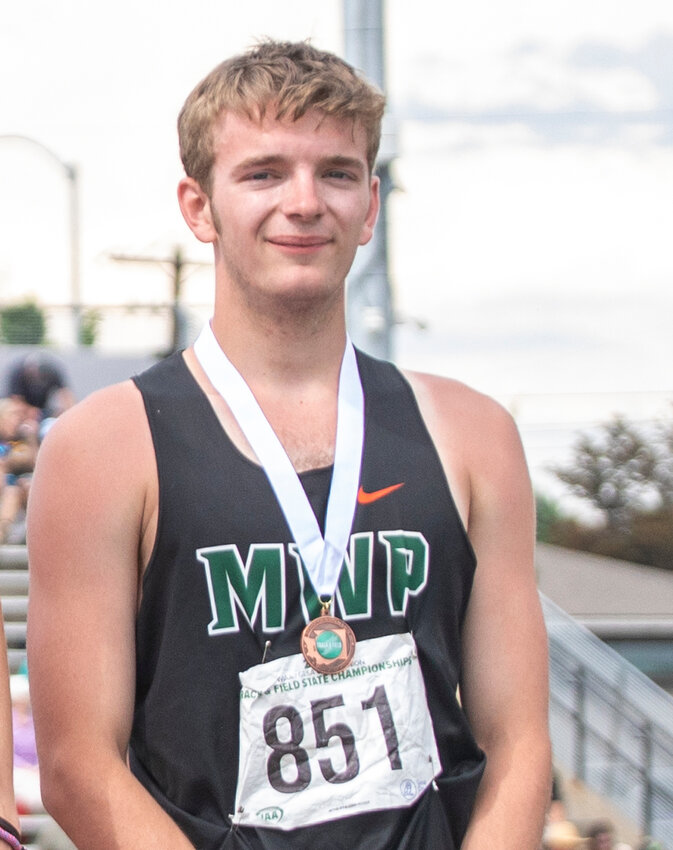 Morton-White Pass athlete Tony Belgiorno stands on the podium, smiling with his medal after placing seventh in the 400 meter dash during 2B boys State track in Yakima on Saturday, May 27.