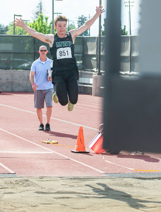 Morton-White Pass athlete Tony Belgiorno flies toward the sand in a jump that would earn him second place for the 2B boys State long jump competition in Yakima on Friday, May 26.