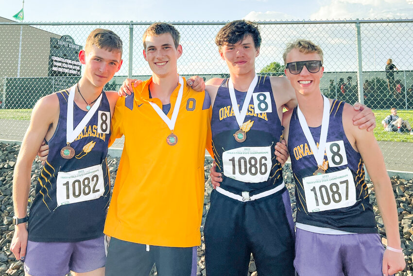 Onalaska runners Riley Carter, Isaac Fitch, Taden Miller and Ben Russon smile for a photo with their eight place medals earned for the 2B boys 1600 meter relay at the State track and field meet in Yakima on Saturday, May 27.