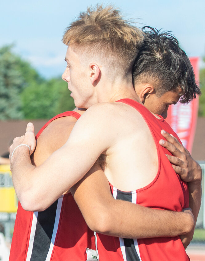 Toledo seniors Jordan McKenzie and Conner Olmstead embrace after winning the 2B State championship during the track and field meet in Yakima on Saturday.