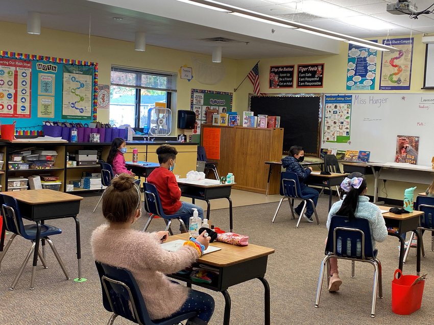 Second-grade students sit on Ms. Harger&rsquo;s classroom at Oakview Elementry School during their first day of in-person classes on Monday.