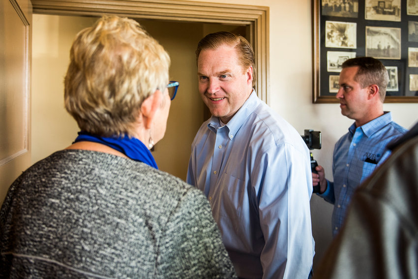 President Kris Johnson, with the Association of Washington Business, smiles and greets Edna Fund as he visits Churchill Glove Co. in October 2019 in downtown Centralia for Manufacturing Week.