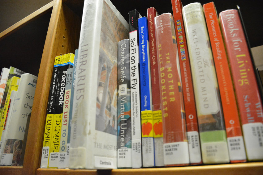 Books line the shelves at a library.