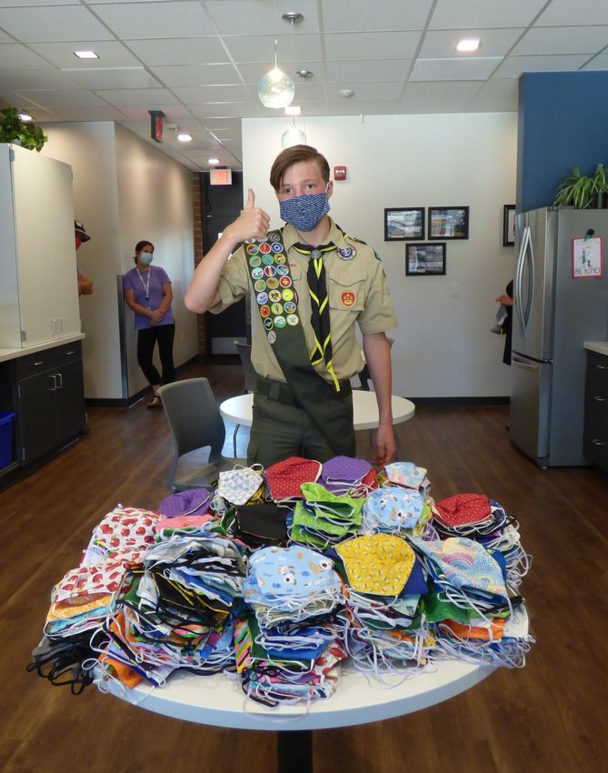 Gavin Gannon displays the cloth masks he completed for his Eagle Scout service project.
