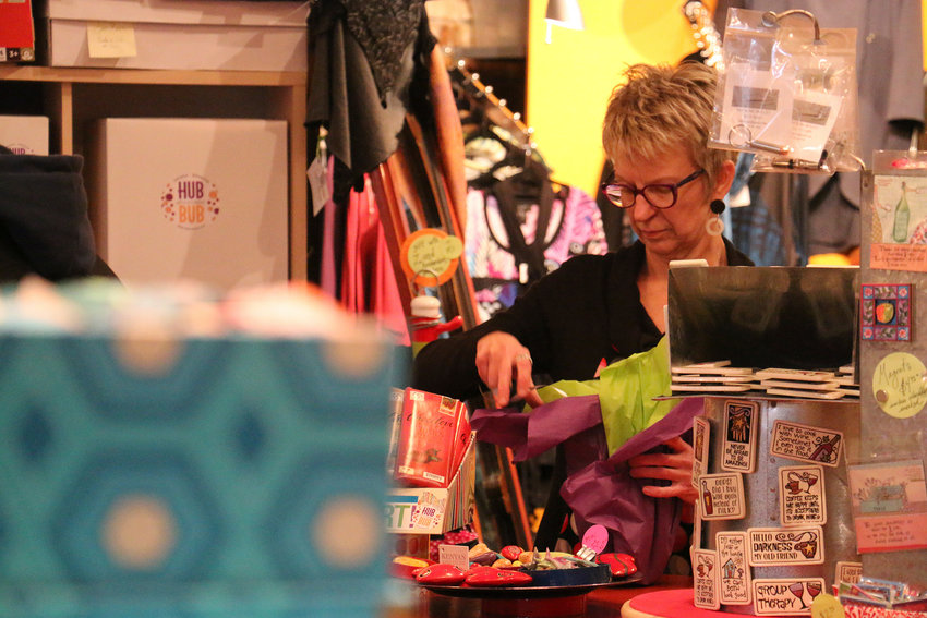 FILE PHOTO &mdash;&nbsp;Rebecca Staebler, owner of HUBBUB, wraps a present for a customer.