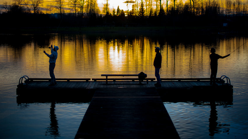 FILE PHOTO &mdash; Anglers fish at South Lewis County Park Pond at sunset on Tuesday, Feb. 23, 2015 in Toledo.