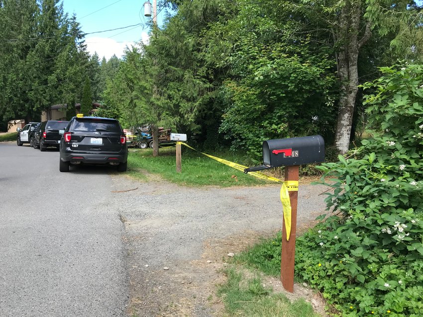 Emergency responders respond after a body was discovered in the Nisqually River Saturday.