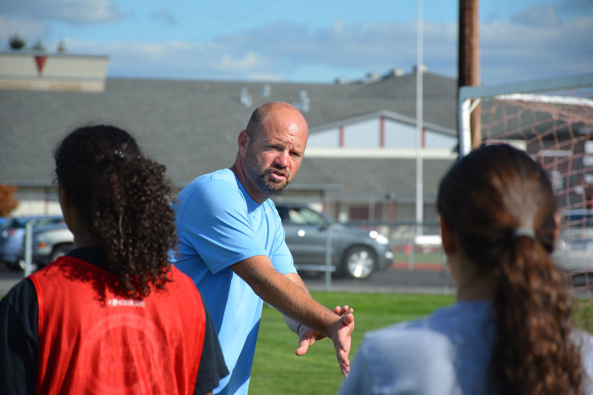 Coach Jay Dorhauer provides information to the girls in this file photo at Gig Harbor.