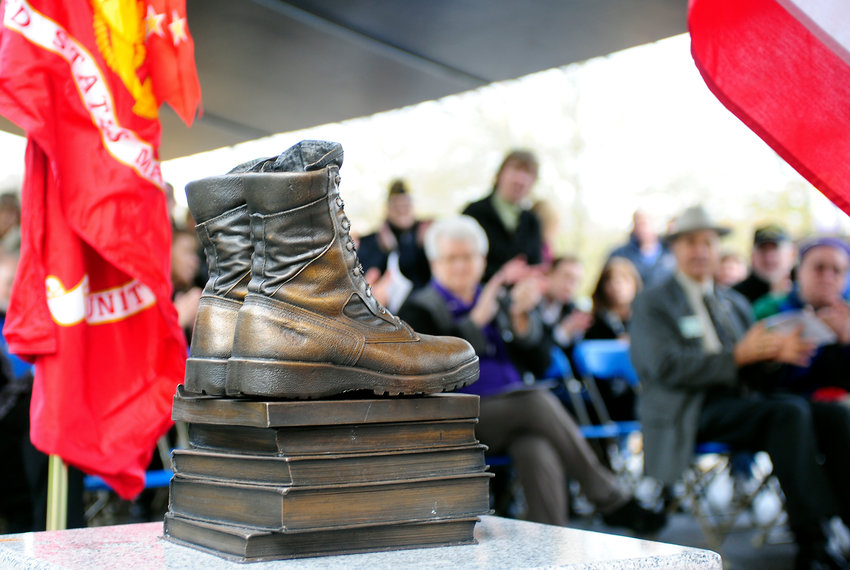 FILE PHOTO &mdash;&nbsp;The audience claps as a statue on Centralia College's campus called Boots-2-Books was revealed in honor of U.S. military veterans past, present and future in this file photo.