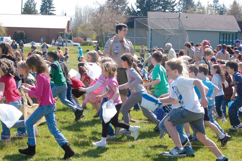 Kids participate in an Easter egg hunt at Yelm City Park in this file photo.