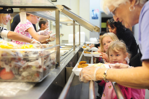 Lunch lady Rosemary Lefebvre, right, helps students get their lunch at Onalaska Elementary School in this file photo.