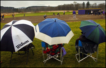 People sit under umbrellas in this file photo.