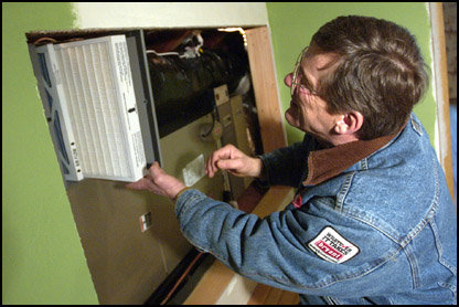 American Home Heating energy consultant Harry Lutz shows the HEPA air filter on the indoor unit of a heat pump in his model home on Galvin Road in Centralia.