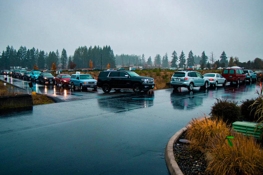 Cars are seen lined up around the parking lot at the Providence Hawks Prairie drive-up COVID-19 testing location last November in Lacey.