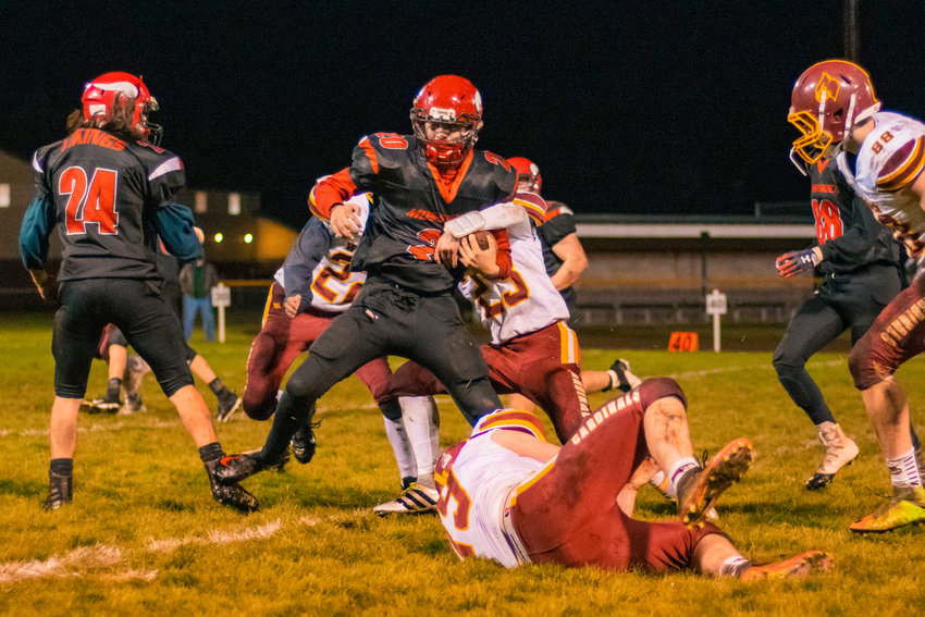 Vikings&rsquo; Matteo Mendoza (20) fights for extra yardage during a game against the Cardinals Friday night in Mossyrock.