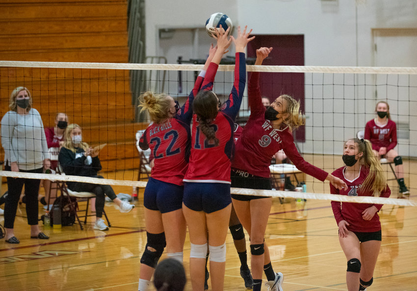W.F. West's Ava Olsen (9) battles at the net with Black Hills' Katelyn Bonds (22) and Payton Childers (12) on Tuesday.