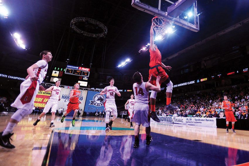 FILE PHOTO &mdash; Morton-White Pass's Zach Walton dunks over Liberty's Tyler Haas during the first quarter of a State 2B Boys Basketball Tournament Championship Game at the Spokane Arena in 2015.