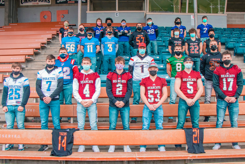 Athletes chosen for the All-Area Football Team pose for a photo at Tiger Stadium sporting their school&rsquo;s football jerseys. Centralia jerseys draped over the seats in front were Benito Valencia (14) and Santos Lafferty (21), who were unable to attend the photo shoot.