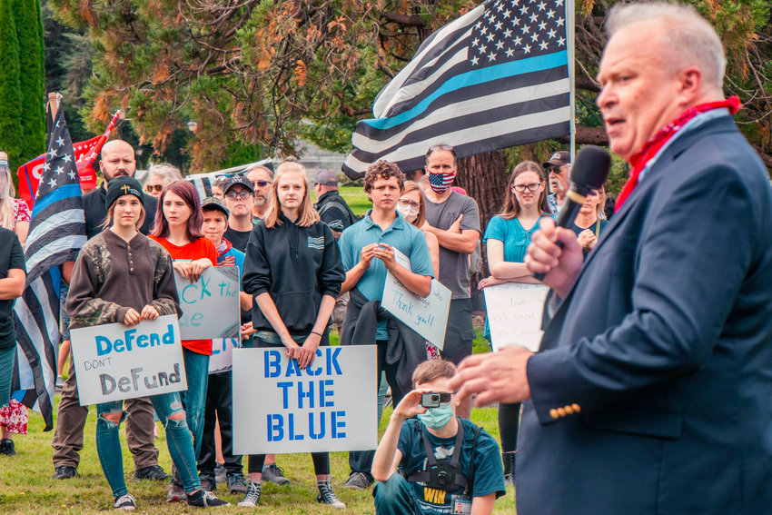 FILE PHOTO &mdash; Republican 19th District Rep. Jim Walsh speaks to demonstrators during a rally in support of law enforcement last August in Olympia.