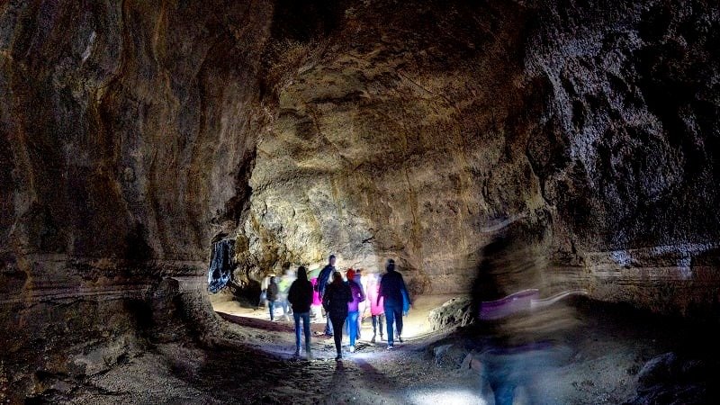 Visitors walk through the Ape Cave in this photograph provided by the U.S. Forest Service.