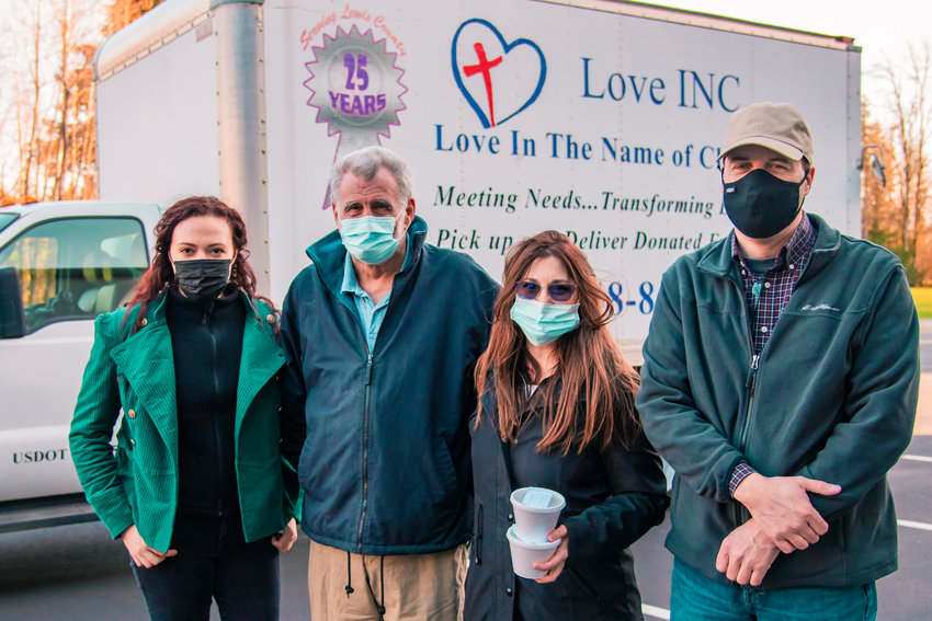From left, volunteer coordinator Payton Zandofsky, warehouse volunteer Dan Gleichman, organizer Melodee Bailey and Executive Director Brian Carlton pose for a photo in front of the Love INC truck parked at Cooks Hill Community Church on Saturday in Centralia during a &ldquo;Souper Supper&rdquo; event.