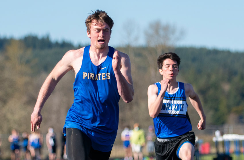 Adna's Zach Berg, left, won the boys 100-meter dash on Tuesday in Adna. Berg led the Pirates with four victories on the day.