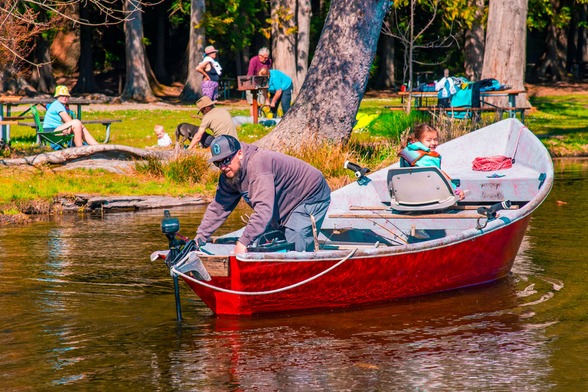 A boat is launched into Deep Lake as families enjoy a sunny day at Millersylvania State Park earlier this year.
