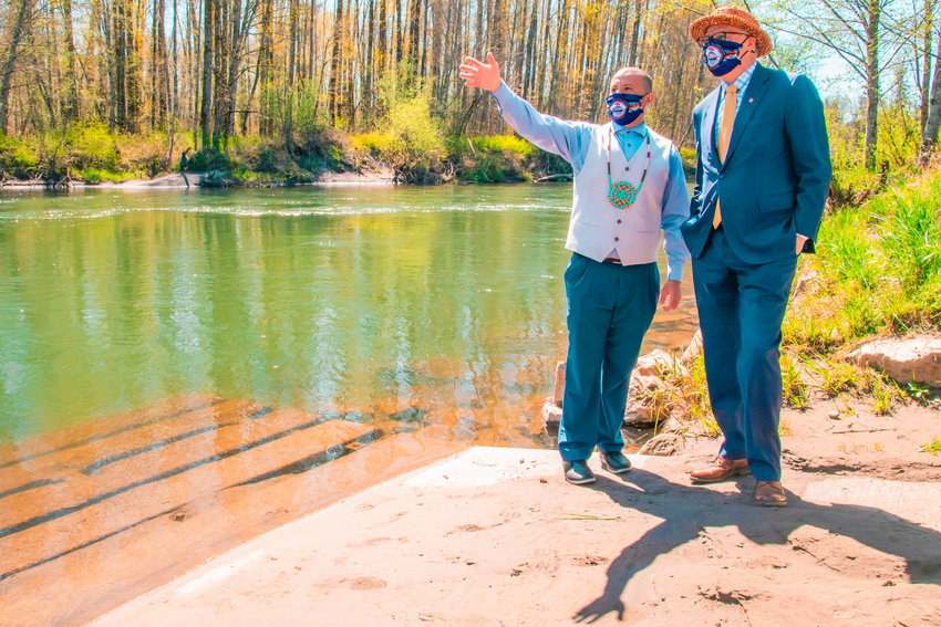 FILE PHOTO &mdash; Willie Frank III talks to Gov. Jay Inslee about his father Billy Frank Jr. and the Nisqually River behind the Wa-He-Lute Indian School at Frank&rsquo;s Landing earlier this year.