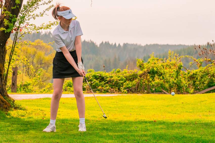 Centralia&rsquo;s Samantha Johnston makes contact with her golf ball at Riverside Golf course in Chehalis on Monday.
