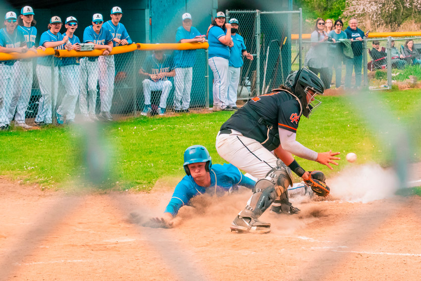 Adna&rsquo;s Levi Gates (24) slides in safe to score during a game against Kalama Thursday afternoon.