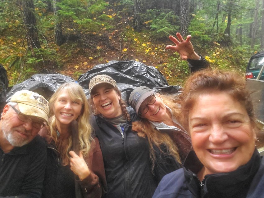 Sheryl Hall, right, and other Gifford Pinchot Trash Force members take a group photo during a cleanup of an illegal roofing dump out on the Forest Service Road 21. It took about three hours to get it cleaned up. The trash is believed to have been dumped seven years ago. It cost about $115 to dump the material at a nearby transfer station.