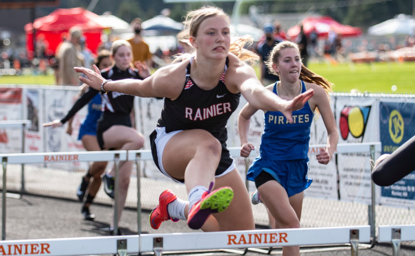 Rainier junior Kaeley Schultz clears a hurdle in the girls 100-meter hurdles at the district championships Thursday. Schultz placed second in the event.