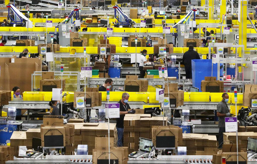 Employees at packing stations are seen at Amazon&rsquo;s Kent fulfillment center, June 11, 2020.