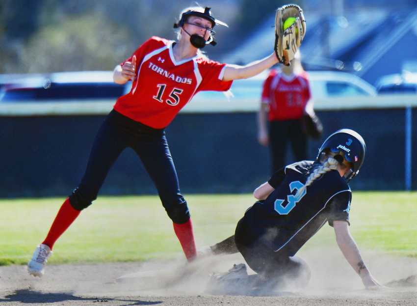 Despite a valiant effort, Yelm High School second baseman Kailei Thompson is unable to tag out Spanaway Lake runner Emily Panush during the teams' softball game on Monday, April 5.