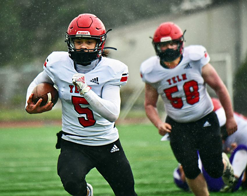 Yelm High School quarterback Kyler Ronquillo scampers for one of his many ground gains against North Thurston High School Friday, March 19, at South Sound Stadium.