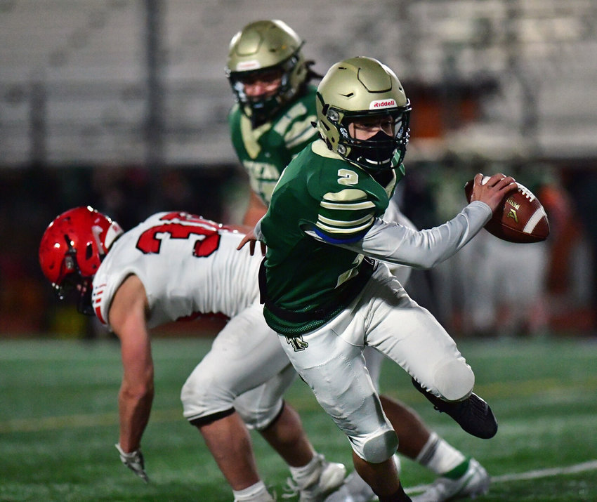 Timberline High School quarterback Palaina Hooper eludes the pursuit of a Yelm High School defender on Friday, March 12, at South Sound Stadium.