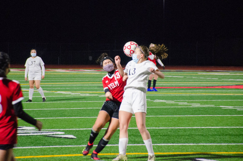 Yelm sophomore Alyssa Forde-Nihipali and River Ridge junior Karissa Leland fight for the ball in a conference matchup Tuesday night between the two teams.&nbsp;