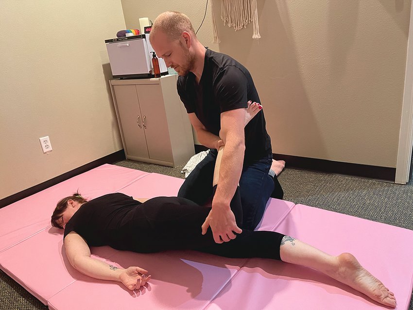 Mat Magick, formerly Kneaded Bliss Massage, now offers mat-based therapy with new massage therapist Ian Brooks, above, as he massages his business and life partner Jennifer Brooks.