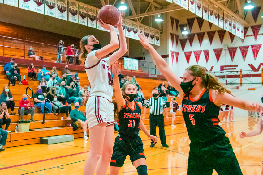 W.F. West&rsquo;s Drea Brumfield (13) shoots over defenders during a game against the Tigers played Monday night in Chehalis.