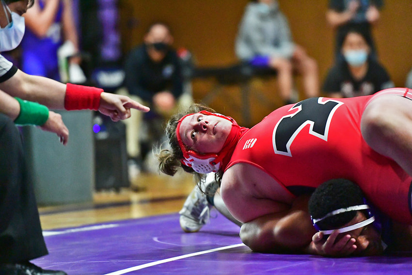 Yelm High School wrestler Slade Edwards, on top &mdash; a senior &mdash; keeps an eye on the referee as he ties up his North Thurston High School opponent on Wednesday, May 12, to win his match on points.
