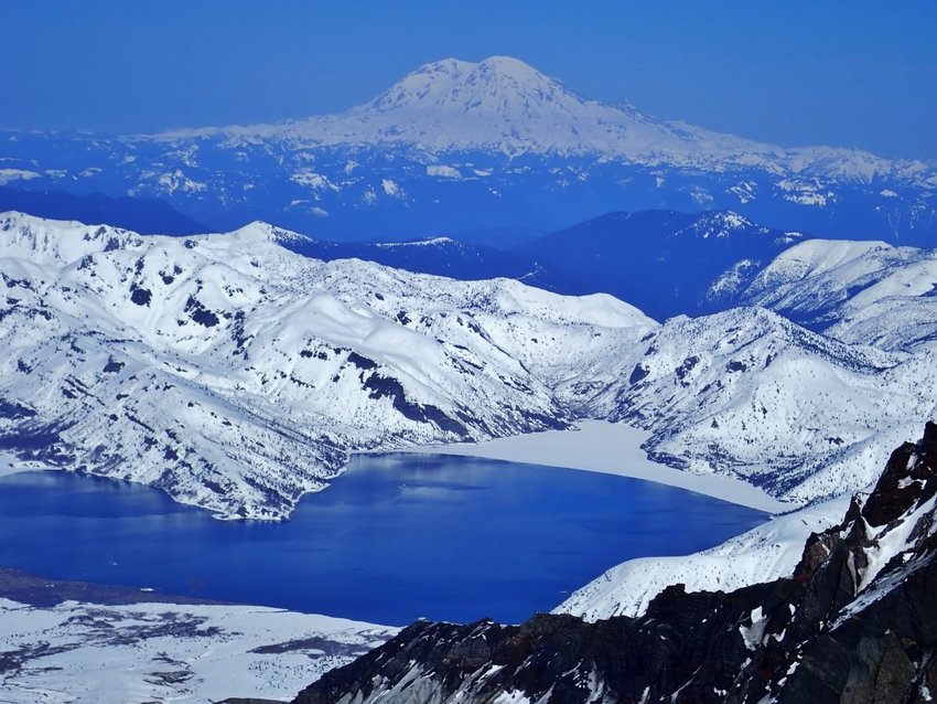 Mount Rainier and Spirit Lake are seen from the summit of Mount St. Helens March 31.