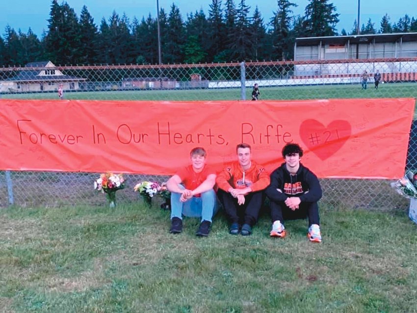 Mikey Green, Carson Edminster and Sean MaHaffey remember their friend Riffe Holmes at a vigil held on May 21.